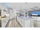 Open concept kitchen with quartz countertops, stainless steel appliances, island and adjacent living area at 16309 Castle Park Ter, Lakewood Ranch, FL 34202