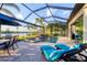 Gorgeous screened-in pool area with lake views, outdoor lounge chairs, and patio seating at 16309 Castle Park Ter, Lakewood Ranch, FL 34202