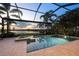 Gorgeous screened-in pool and spa with a peaceful lake view and lush landscaping at 16309 Castle Park Ter, Lakewood Ranch, FL 34202