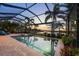 Inviting screened-in pool and spa area offering serene views of the lake at 16309 Castle Park Ter, Lakewood Ranch, FL 34202
