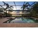 Sparkling screened-in pool and spa with a tranquil lake view at sunset at 16309 Castle Park Ter, Lakewood Ranch, FL 34202