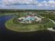 Aerial view showcases the community pool surrounded by tropical palm trees and lush landscaping at 16309 Castle Park Ter, Lakewood Ranch, FL 34202