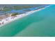 Expansive aerial view of the pristine shoreline with clear turquoise waters and natural landscapes at 1680 Lemon Bay Dr, Venice, FL 34293