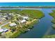 Magnificent aerial showcases the property near the bay with waterfront access and dockage at 1680 Lemon Bay Dr, Venice, FL 34293
