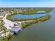 Aerial view of a waterfront property, featuring boat house, canal access and ample parking space at 1680 Lemon Bay Dr, Venice, FL 34293