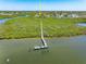 Charming aerial view of the waterfront home with a private dock and lush surroundings at 1680 Lemon Bay Dr, Venice, FL 34293