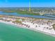 Stunning aerial shot of the coastline highlighting a sandy beach, clear waters, and nearby neighborhood at 1680 Lemon Bay Dr, Venice, FL 34293