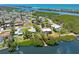 Aerial view of the home highlighting its waterfront location, private dock, and lush landscaping at 1680 Lemon Bay Dr, Venice, FL 34293