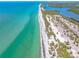 Scenic aerial view of a coastline, displaying the contrast between the ocean and vegetation at 1680 Lemon Bay Dr, Venice, FL 34293