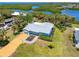 A beautiful aerial view showcases the entire property with the driveway and backyard landscaping at 1680 Lemon Bay Dr, Venice, FL 34293