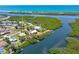 Aerial view of the home highlighting its waterfront location, private dock, and lush landscaping at 1680 Lemon Bay Dr, Venice, FL 34293