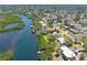 Waterfront home featuring lush greenery and a private dock providing direct access to the water at 1680 Lemon Bay Dr, Venice, FL 34293