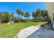 Beautiful backyard featuring palm trees and a private dock leading to the water at 1680 Lemon Bay Dr, Venice, FL 34293