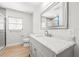 Bright bathroom featuring a marble vanity, toilet, and window at 1680 Lemon Bay Dr, Venice, FL 34293
