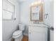 Bathroom featuring a marble vanity with bronze fixtures at 1680 Lemon Bay Dr, Venice, FL 34293
