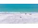 Scenic aerial view of a sandy beach with crystal-clear turquoise waters at 1680 Lemon Bay Dr, Venice, FL 34293