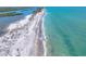Aerial view of a picturesque beach with clear turquoise waters, perfect for swimming and relaxation at 1680 Lemon Bay Dr, Venice, FL 34293