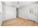 Bedroom featuring wood-look floors, closet, and access to the backyard at 1680 Lemon Bay Dr, Venice, FL 34293