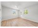 Simple bedroom with tile floors, two windows, a ceiling fan, and neutral paint at 1680 Lemon Bay Dr, Venice, FL 34293