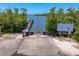 View of the boat ramp with access to the water, lush foliage on both sides and signage visible at 1680 Lemon Bay Dr, Venice, FL 34293
