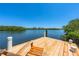 A new wooden chair sits on a new dock with lovely views of a lagoon surrounded by mangroves at 1680 Lemon Bay Dr, Venice, FL 34293
