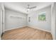 Bright, empty room with wood-look floors, neutral paint, and natural light at 1680 Lemon Bay Dr, Venice, FL 34293