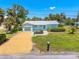 Charming single-story home with a well-manicured lawn, walkway, and appealing curb appeal at 1680 Lemon Bay Dr, Venice, FL 34293