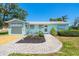 Charming home featuring a well-manicured front yard and a welcoming entryway at 1680 Lemon Bay Dr, Venice, FL 34293