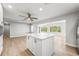 Bright kitchen with a center island, ceiling fan, and views to the living space at 1680 Lemon Bay Dr, Venice, FL 34293