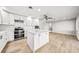 Updated kitchen featuring modern fixtures, a tile backsplash, stainless appliances, and a center island at 1680 Lemon Bay Dr, Venice, FL 34293