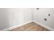 Laundry room features wood-look floors and utility hookups at 1680 Lemon Bay Dr, Venice, FL 34293