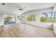 Open living room with tile floors, a ceiling fan, and natural light flooding in from the windows at 1680 Lemon Bay Dr, Venice, FL 34293