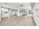 Bright, open living space with tile flooring connecting to the kitchen and screened-in patio at 1680 Lemon Bay Dr, Venice, FL 34293