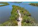 Serene view of a lush tropical island trail leading to a beautiful ocean at 1680 Lemon Bay Dr, Venice, FL 34293