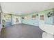 Spacious screened porch with a ceiling fan, neutral walls, and sliding glass doors for seamless indoor-outdoor living at 1680 Lemon Bay Dr, Venice, FL 34293