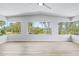 Bright sun room with large windows offering beautiful views of the waterway at 1680 Lemon Bay Dr, Venice, FL 34293