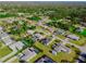 Aerial view showcasing a residential neighborhood featuring lush greenery and community pools at 18182 Steele Ave, Port Charlotte, FL 33948