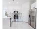 Modern kitchen with white cabinetry, stainless steel appliances, and sleek countertops in a bright, open space at 18182 Steele Ave, Port Charlotte, FL 33948
