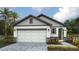 Charming single-story home with a two-car garage, stone accents, and landscaped front yard at 1848 Cobb Trl, Parrish, FL 34219