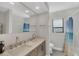 Bathroom with double vanity, tiled backsplash, and a shower with ocean-themed curtain at 2301 Cass St, Sarasota, FL 34231