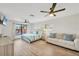 Bright bedroom features a queen bed, couch, ceiling fan and window overlooking a pool at 2301 Cass St, Sarasota, FL 34231