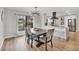 Dining room features a modern chandelier and flows into a kitchen with sleek, white cabinetry at 2301 Cass St, Sarasota, FL 34231