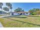 Single-story home boasts a well-manicured lawn, a terra cotta roof and attached garage at 2301 Cass St, Sarasota, FL 34231