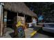 Rustic outdoor dining area features a thatched roof and signage with awards at 2301 Cass St, Sarasota, FL 34231