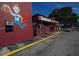 Exterior of restaurant features large mural, signage, and convenient parking at 2301 Cass St, Sarasota, FL 34231