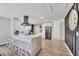 Modern kitchen featuring a waterfall island, stainless steel appliances, and sleek white cabinets at 2301 Cass St, Sarasota, FL 34231