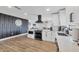 Well-lit modern kitchen with quartz counters, stainless steel appliances, and seamless flow to living space at 2301 Cass St, Sarasota, FL 34231