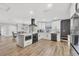 This contemporary kitchen boasts a waterfall island, stainless steel appliances, and dining area access at 2301 Cass St, Sarasota, FL 34231