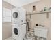 Laundry room with stacked washer and dryer and utility sink at 2301 Cass St, Sarasota, FL 34231