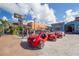 Eclectic beach vehicles parked in front of shops, set against a backdrop of palm trees and sunny skies at 2301 Cass St, Sarasota, FL 34231